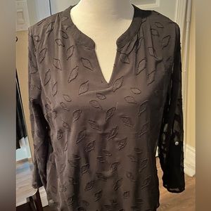 Black dress shirt with sheer sleeves.